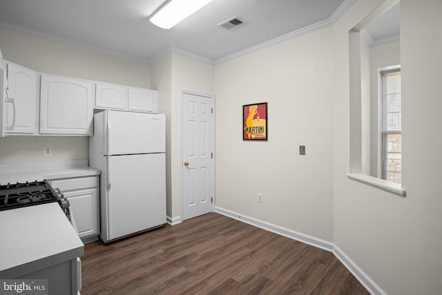 kitchen with dark wood-style floors, crown molding, light countertops, freestanding refrigerator, and white cabinetry