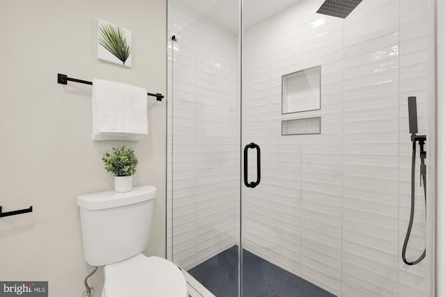 bathroom with a stall shower and toilet