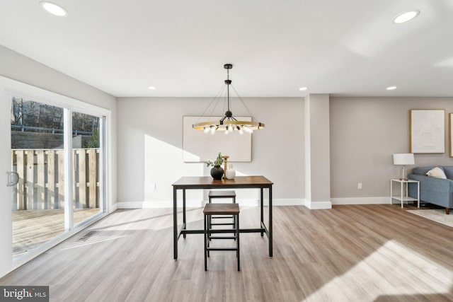 dining area with baseboards, recessed lighting, and light wood-style floors