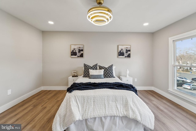 bedroom with recessed lighting, baseboards, and wood finished floors