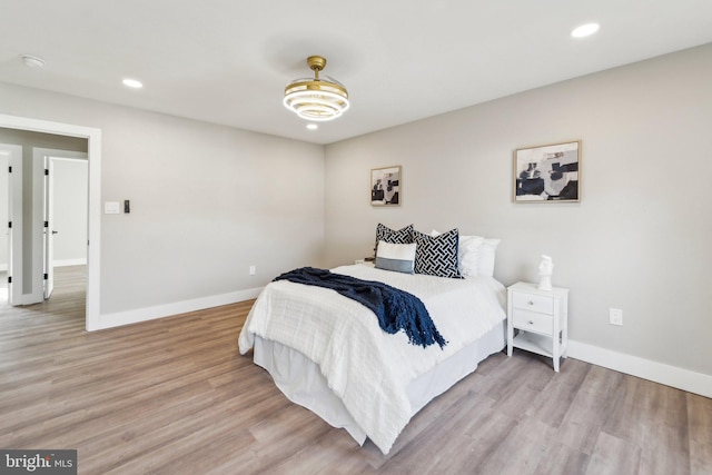 bedroom featuring light wood finished floors, recessed lighting, and baseboards