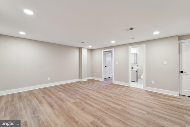 spare room with baseboards, light wood-style flooring, visible vents, and recessed lighting