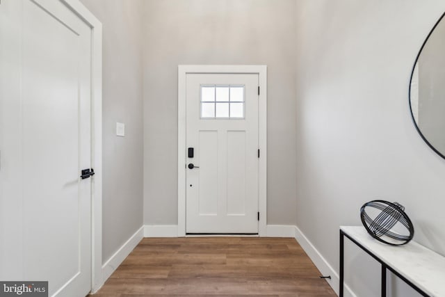 entryway with baseboards and wood finished floors