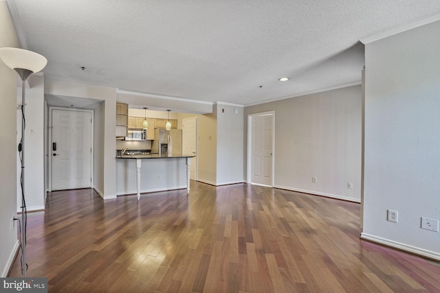 unfurnished living room with baseboards, a textured ceiling, ornamental molding, and dark wood-style flooring