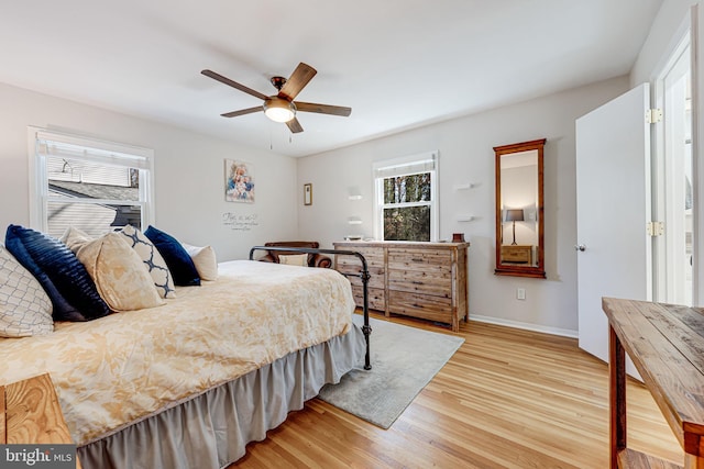 bedroom featuring light wood-style flooring, baseboards, and ceiling fan