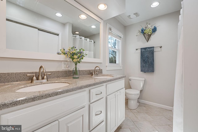 bathroom with visible vents, a sink, toilet, and baseboards