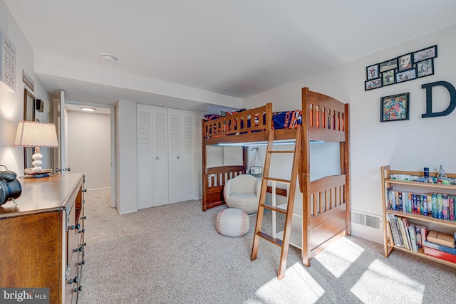 bedroom featuring a closet, carpet, and visible vents