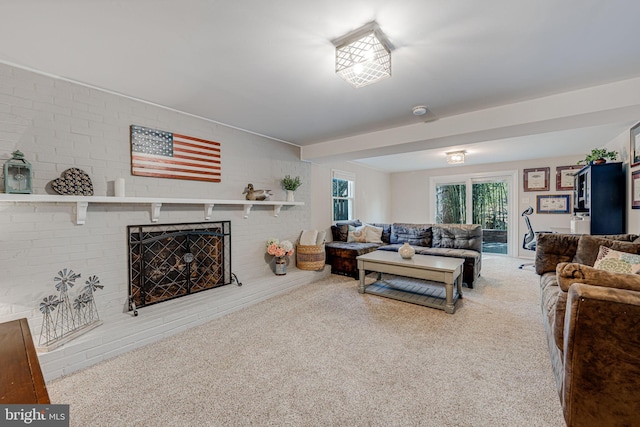 living area featuring carpet floors, plenty of natural light, and a fireplace