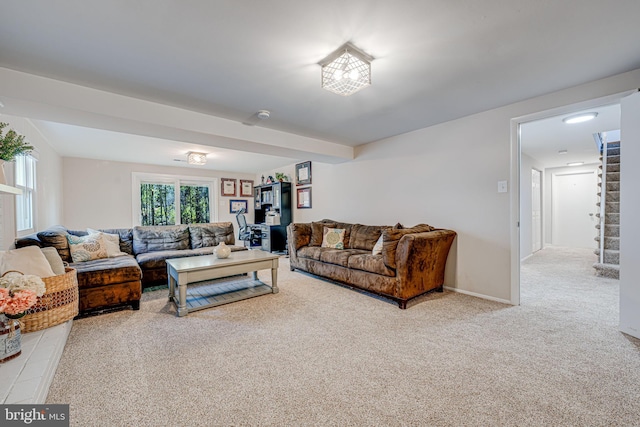 living room with carpet floors, baseboards, and stairway