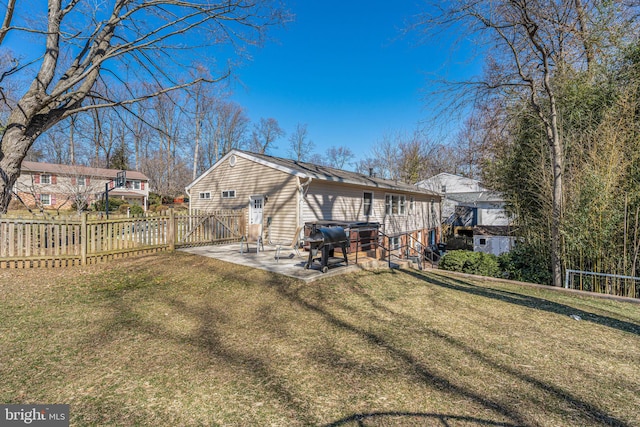 rear view of property with a patio area, a lawn, and fence