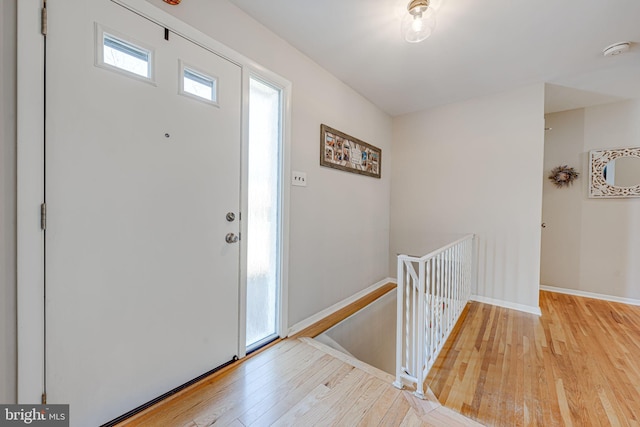 entrance foyer featuring wood-type flooring and baseboards