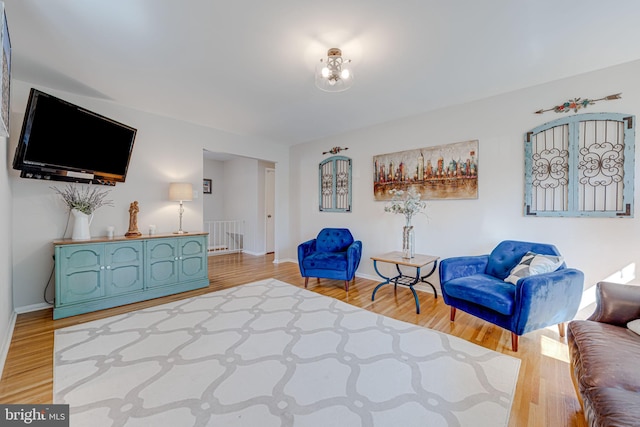 sitting room featuring light wood finished floors and baseboards