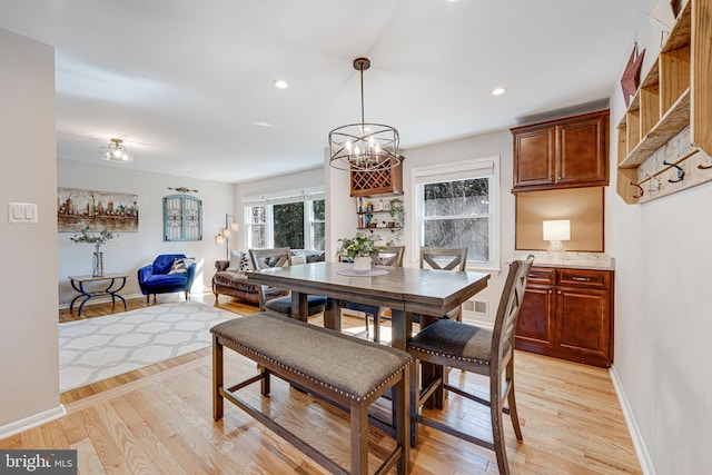 dining room with visible vents, baseboards, light wood-type flooring, a notable chandelier, and recessed lighting