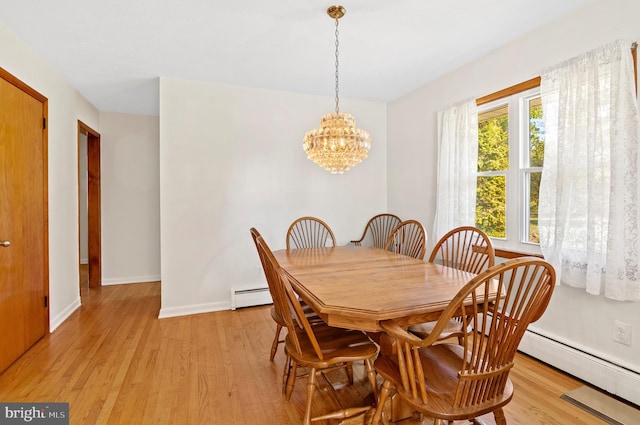 dining room with light wood-style floors, a baseboard radiator, baseboards, and a notable chandelier