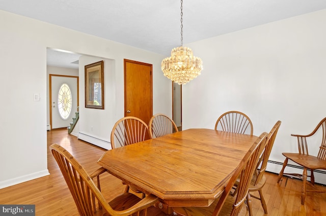 dining area with light wood-type flooring, an inviting chandelier, baseboards, and a baseboard heating unit