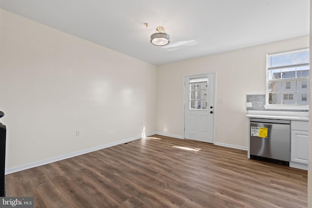 interior space featuring baseboards and dark wood finished floors