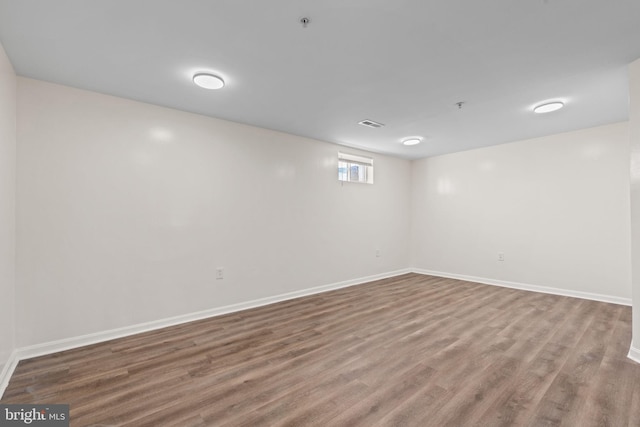 below grade area with baseboards and wood finished floors