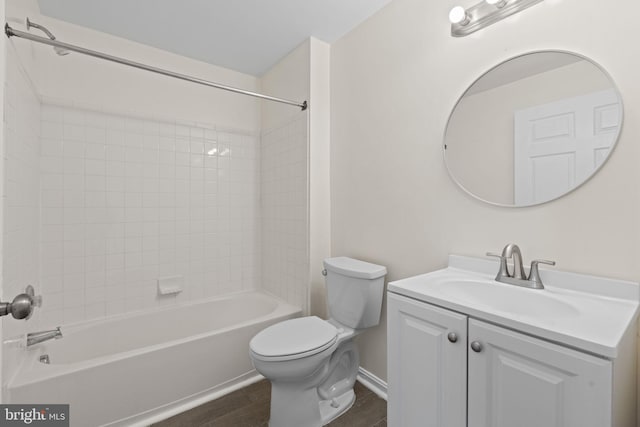 full bath featuring baseboards, toilet, wood finished floors, vanity, and shower / washtub combination