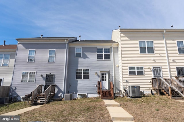 back of property with a lawn and central AC unit