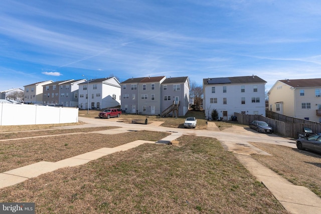 view of yard featuring fence and a residential view