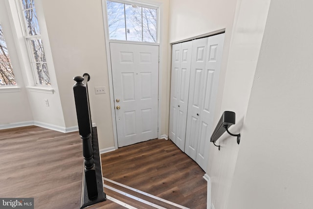 entryway featuring dark wood-style flooring and baseboards