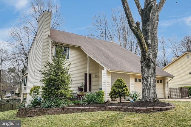 view of front of home with a front yard, driveway, a shingled roof, a chimney, and a garage