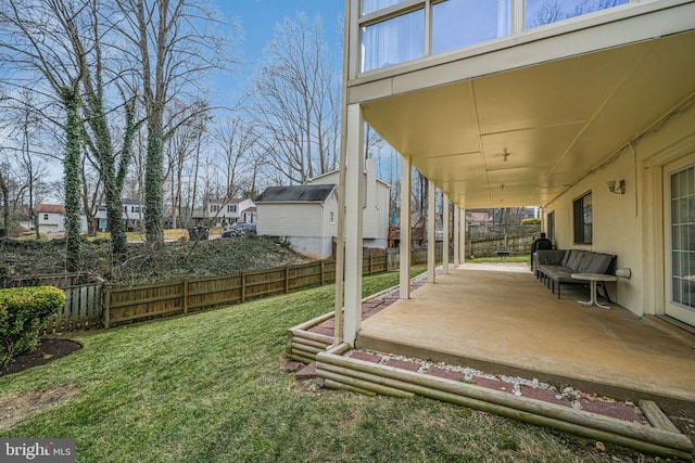 view of yard with a patio area, a residential view, and a fenced backyard