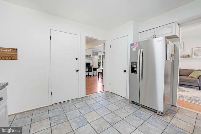 kitchen featuring light tile patterned floors, white cabinetry, and stainless steel fridge with ice dispenser