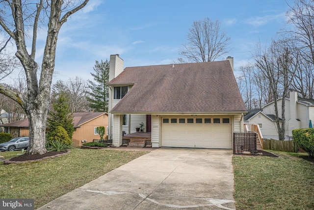 view of front facade with an attached garage, a chimney, driveway, and a front yard