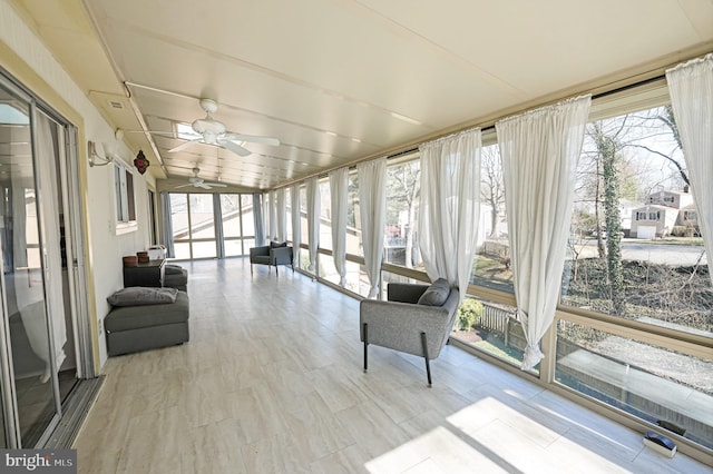 sunroom with plenty of natural light and a ceiling fan