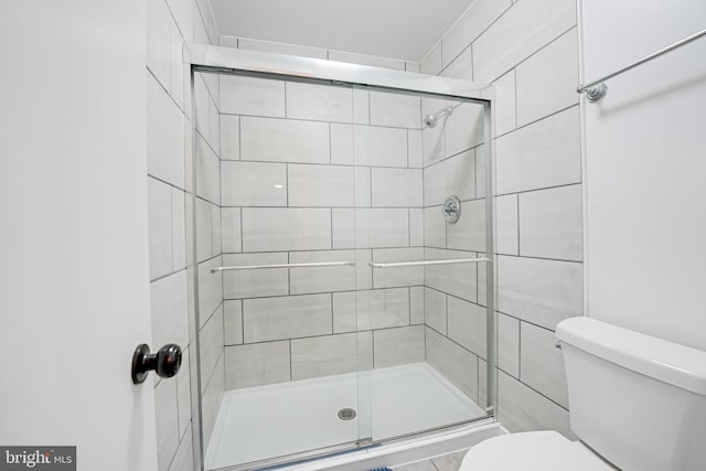 full bath with a stall shower and toilet