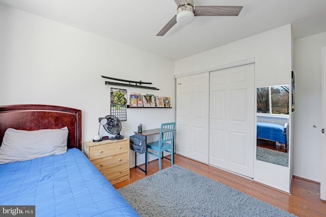 bedroom with a closet, ceiling fan, and wood finished floors