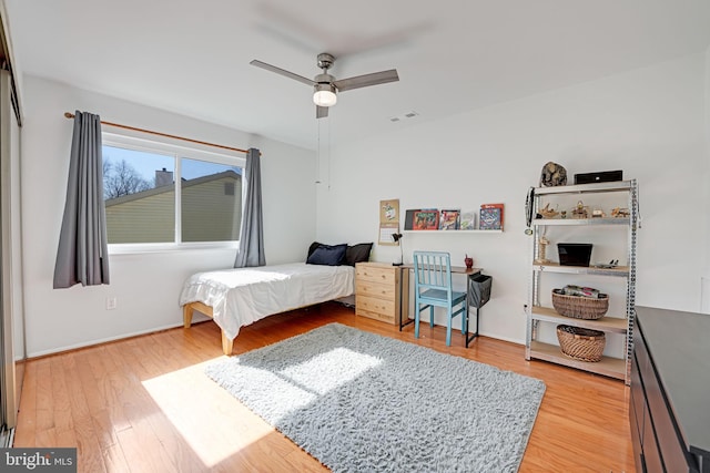 bedroom featuring a ceiling fan, visible vents, and light wood-type flooring