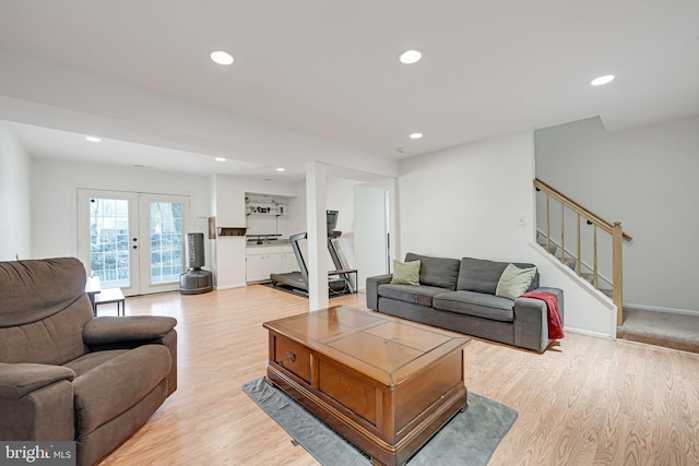 living room with light wood finished floors, baseboards, stairs, recessed lighting, and french doors