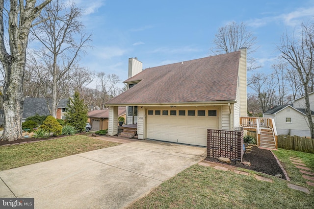 view of front of house featuring driveway, an attached garage, a chimney, and a shingled roof