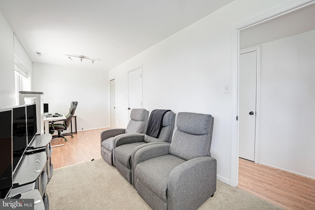 living room with visible vents, baseboards, and light wood-style floors