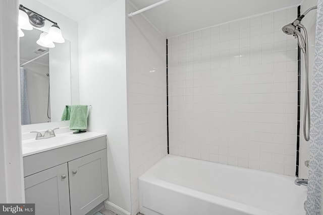 full bath featuring vanity and shower / bath combo