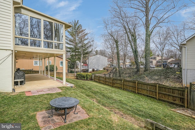 view of yard with a patio area, fence, and a sunroom