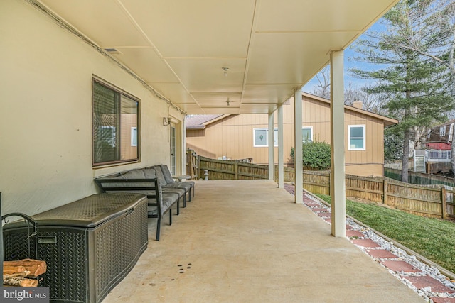 view of patio featuring fence