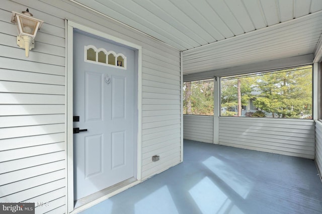 view of exterior entry with a porch