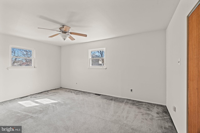 spare room featuring carpet floors and ceiling fan