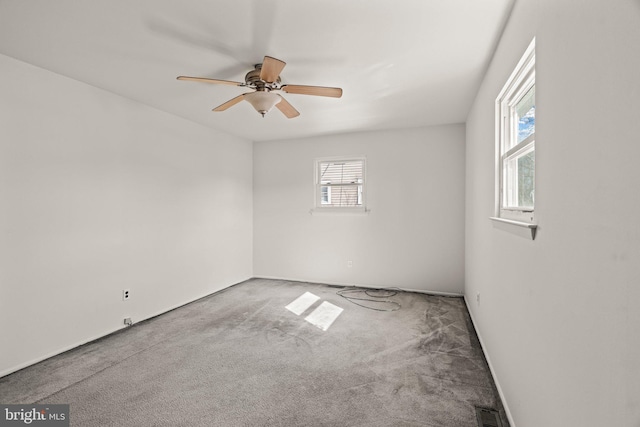 unfurnished room with ceiling fan, carpet flooring, and visible vents