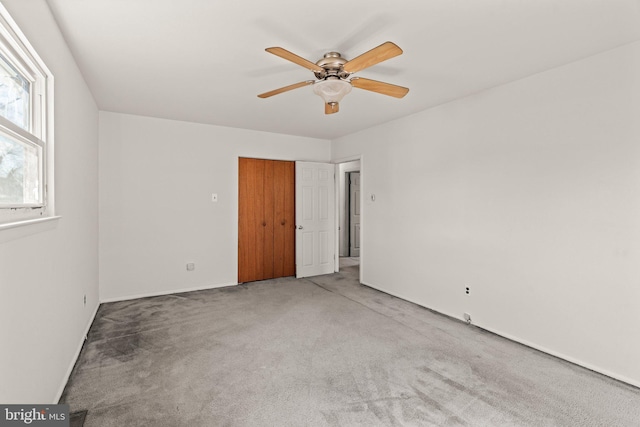 carpeted empty room with ceiling fan