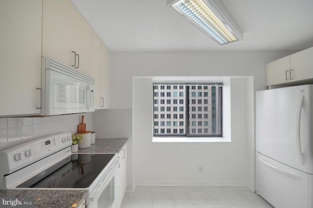 kitchen featuring white appliances, baseboards, and decorative backsplash