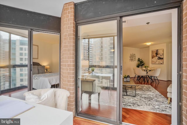 entryway featuring a city view and wood finished floors