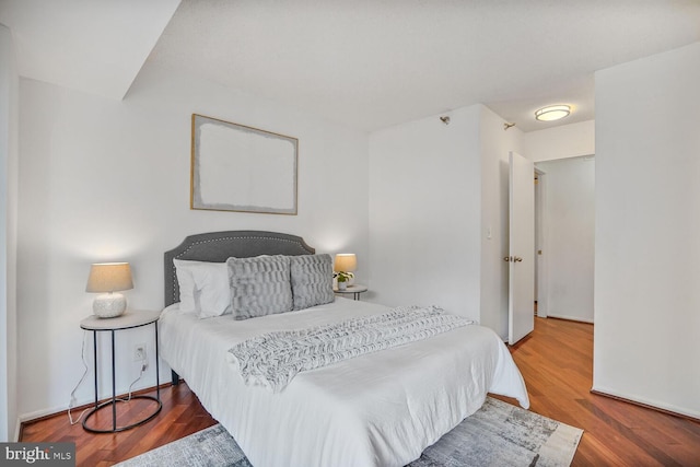 bedroom featuring wood finished floors