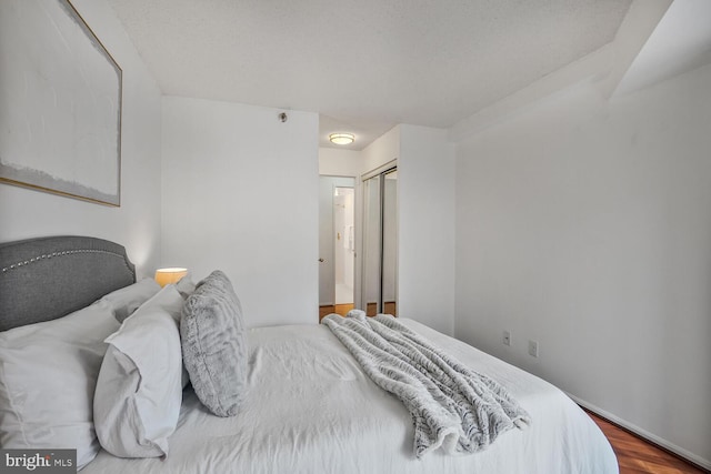 bedroom with a closet and wood finished floors