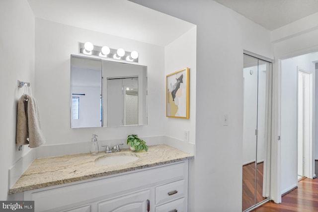 bathroom featuring wood finished floors and vanity