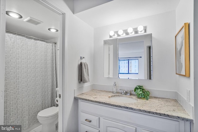 full bathroom featuring toilet, vanity, and visible vents