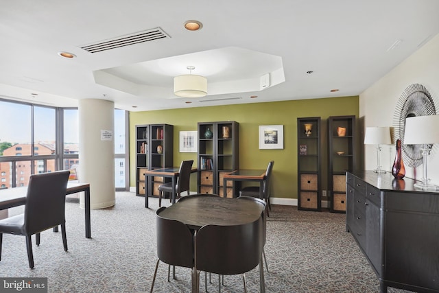 carpeted dining space featuring recessed lighting, a raised ceiling, visible vents, and baseboards